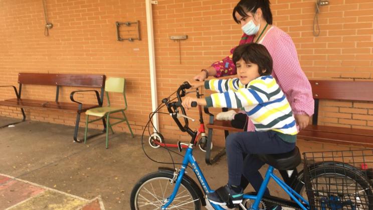 Boy riding a new bike.